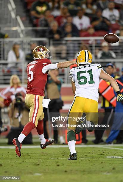 Christian Ponder of the San Francisco 49ers gets his pass off under pressure from outside linebacker Kyler Fackrell of the Green Bay Packers in the...