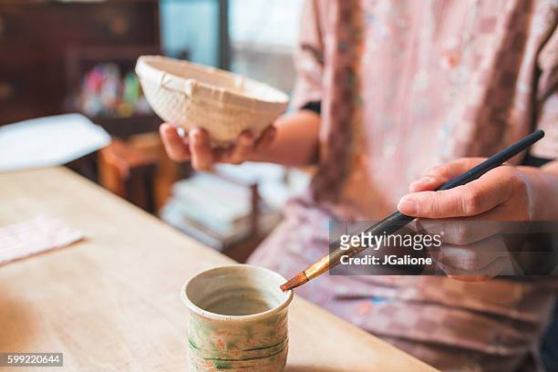 craftsperson handpainting a paper bowl - papier stock pictures, royalty-free photos & images