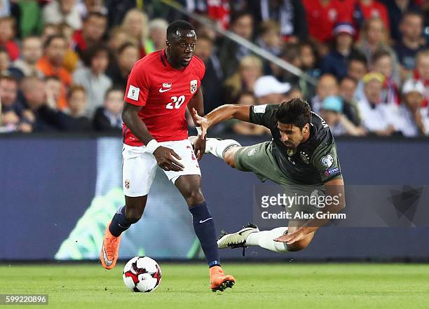 Adama Diomande of Norway challenges Sami Khedira of Germany during the 2018 FIFA World Cup Qualifier Group C match between Norway and Germany at...