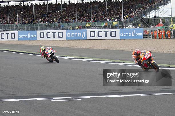 Marc Marquez of Spain and Repsol Honda Team leads Andrea Iannone of Italy and Ducati Team during the MotoGP race during the MotoGp Of Great Britain -...