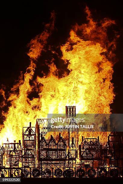 Replica of 17th-century London on a barge floating on the river Thames burns in an event to mark the 350th anniversary of the Great Fire of London,...