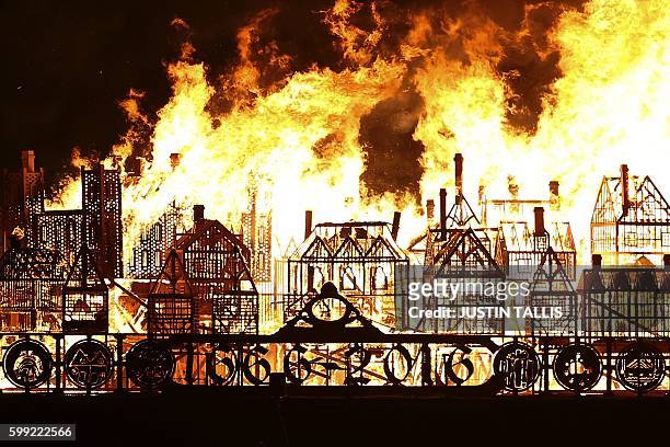 Replica of 17th-century London on a barge floating on the river Thames burns in an event to mark the 350th anniversary of the Great Fire of London,...