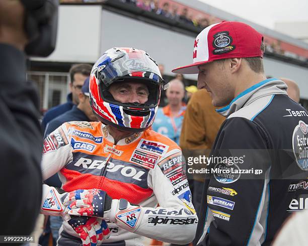 Mick Doohan of Australia speaks with Jack Miller of Australia and Marc VDS Racing Team during the Barry Sheene Parade during the MotoGp Of Great...