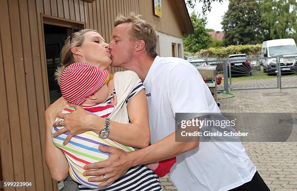 Eva-Maria Grein and her husband Christoph von Friedl and their baby son Jonathan during the charity football game 'Kick for Kids' to benefit 'Die...