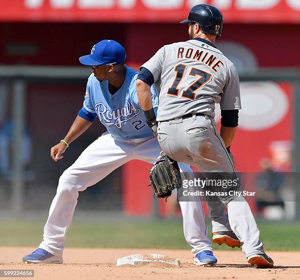 Detroit Tigers' Andrew Romine reaches second in front of Kansas City Royals shortstop Alcides Escobar on an RBI double that scored Tyler Collins in...
