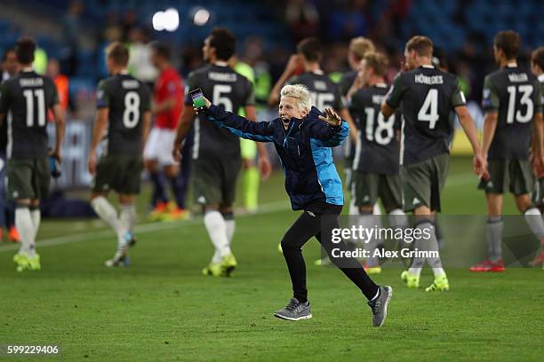 Fan celebrates after taking a selfie with German team captain Manuel Neuer after the 2018 FIFA World Cup Qualifier Group C match between Norway and...