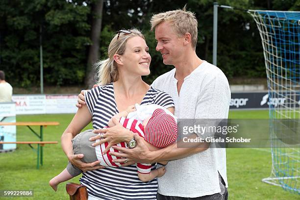 Eva-Maria Grein and her husband Christoph von Friedl and their baby son Jonathan during the charity football game 'Kick for Kids' to benefit 'Die...