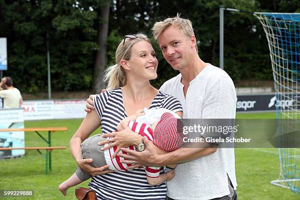 Eva-Maria Grein and her husband Christoph von Friedl and their baby son Jonathan during the charity football game 'Kick for Kids' to benefit 'Die...