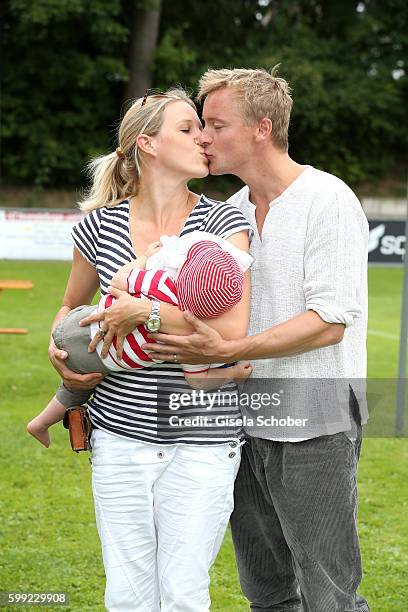 Eva-Maria Grein and her husband Christoph von Friedl and their baby son Jonathan during the charity football game 'Kick for Kids' to benefit 'Die...