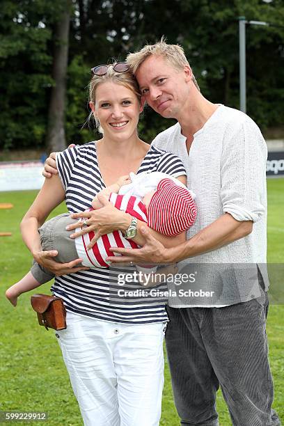 Eva-Maria Grein and her husband Christoph von Friedl and their baby son Jonathan during the charity football game 'Kick for Kids' to benefit 'Die...