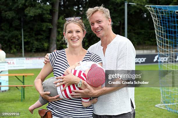 Eva-Maria Grein and her husband Christoph von Friedl and their baby son Jonathan during the charity football game 'Kick for Kids' to benefit 'Die...