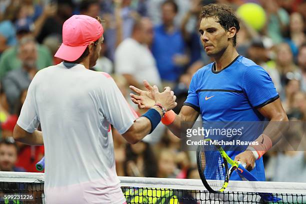 Lucas Pouille of France shakes hands after defeating Rafael Nadal of Spain during his fourth round Men's Singles match on Day Seven of the 2016 US...