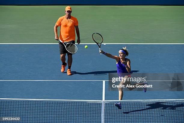 Nicole Gibbs and Dennis Novikov of the United States return a shot to Hao-Ching Chan of Chinese Taipei and Max Mirnyi of Belarus during their second...