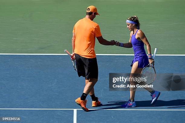 Nicole Gibbs and Dennis Novikov of the United States react against Hao-Ching Chan of Chinese Taipei and Max Mirnyi of Belarus during their second...