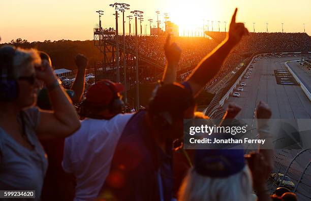 Race fans watch the NASCAR Sprint Cup Series Bojangles' Southern 500 during sunset at Darlington Raceway on September 4, 2016 in Darlington, South...