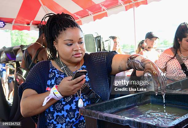 Fans get their arms dipped in body paint during the 2016 Budweiser Made in America Festival - Day 2 at Benjamin Franklin Parkway on September 4, 2016...