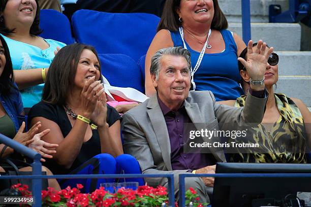 Manuel Santana, former amateur tennis champion from Spain, waves as Lucas Pouille of France plays against Rafael Nadal of Spain during their fourth...