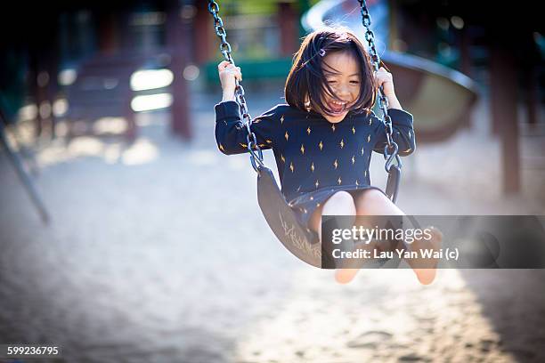 simple pleasures - playground swing stock pictures, royalty-free photos & images