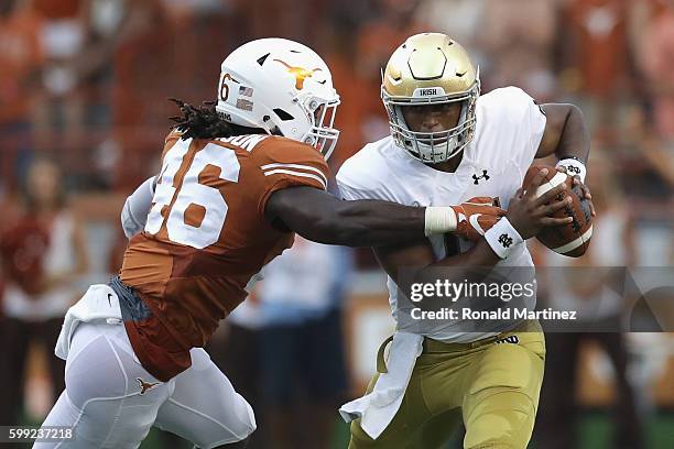 Malik Jefferson of the Texas Longhorns sacks DeShone Kizer of the Notre Dame Fighting Irish during the first half at Darrell K. Royal-Texas Memorial...