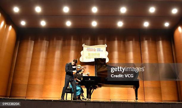 British violinist Charlie Siem performs onstage in his national tour on September 3, 2016 in Nanjing, Jiangsu Province of China.