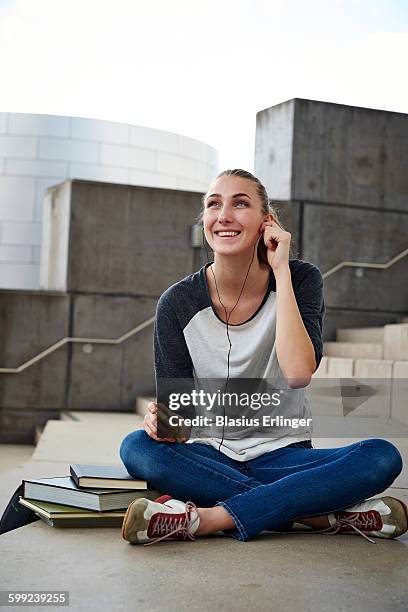 young woman at university - person looking at phone while smiling australia stock pictures, royalty-free photos & images