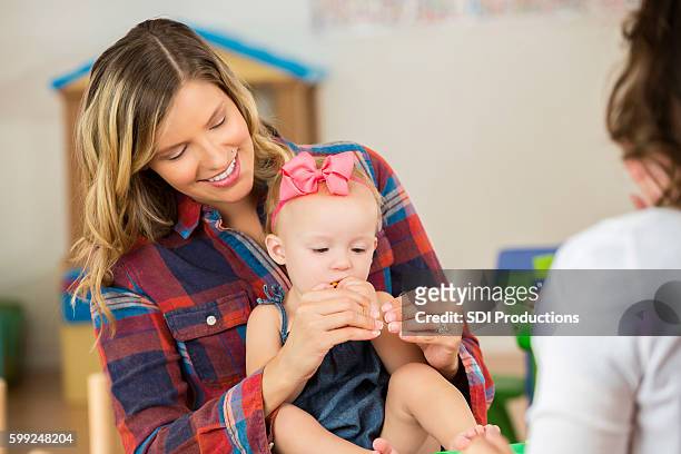 mother with her cute toddler daughter practice sign language - american sign language stock pictures, royalty-free photos & images