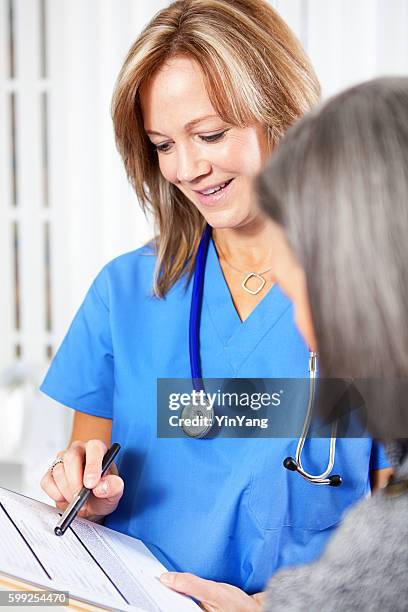 nurse helping senior patient with forms and paper work - clipboard stock pictures, royalty-free photos & images