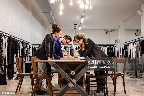 new business clothing store, team at work on new arrivals - clothing design studio stock pictures, royalty-free photos & images