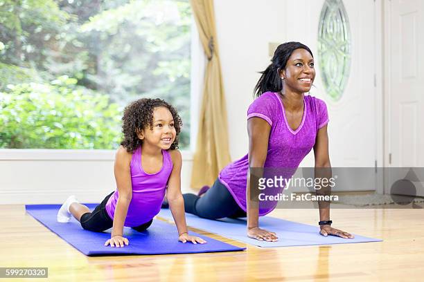 african american mother and daughter doing yoga - fat black girl stock pictures, royalty-free photos & images