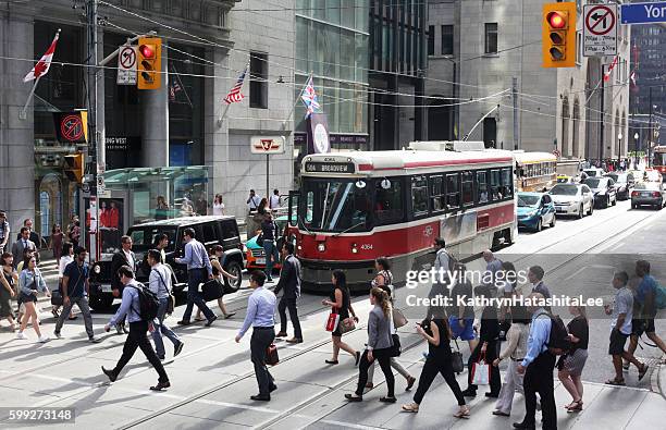 people crossing king street at yonge, downtown toronto, ontario, canada - toronto downtown stock pictures, royalty-free photos & images