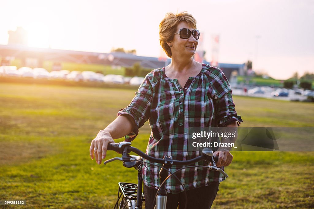 Healthy overweight woman riding bicycle