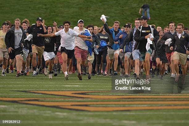 Wake Forest freshman students run across the field prior to the game between the Tulane Green Wave and the Wake Forest Demon Deacons at BB&T Field on...