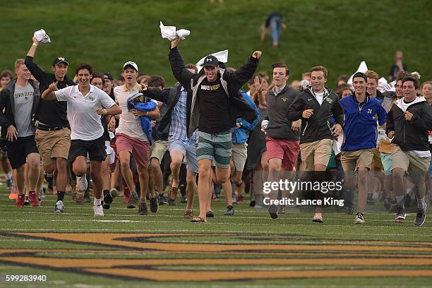 Wake Forest freshman students run across the field prior to the game between the Tulane Green Wave and the Wake Forest Demon Deacons at BB&T Field on...