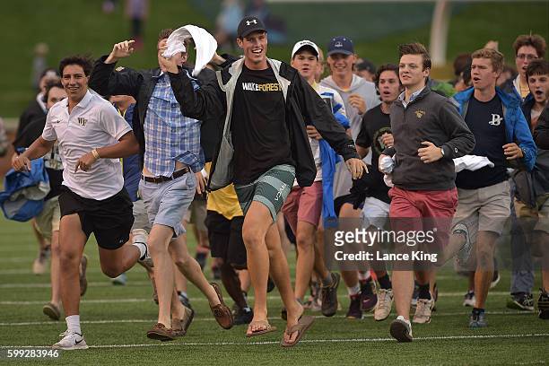 Wake Forest freshman students run across the field prior to the game between the Tulane Green Wave and the Wake Forest Demon Deacons at BB&T Field on...