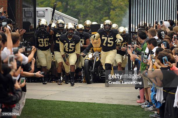 The mascot and players of the Wake Forest Demon Deacons enter the stadium prior to their game against the Tulane Green Wave at BB&T Field on...