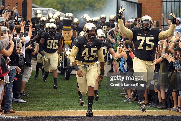 Players of the Wake Forest Demon Deacons run onto the field prior to their game against the Tulane Green Wave at BB&T Field on September 1, 2016 in...