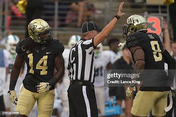 Wendell Dunn and Marquel Lee of the Wake Forest Demon Deacons react following a play against the Tulane Green Wave at BB&T Field on September 1, 2016...