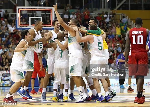 Canada's Anthony Bennett walks past Brazilian players as they celebrate after defeating Canada in the men's basektball final at the Toronto 2015...