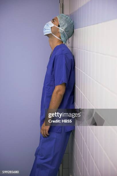 doctor leaning against wall - surgical mask profile stock pictures, royalty-free photos & images