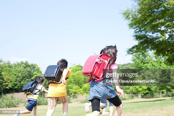 schoolchildren running - 子供のみ ストックフォトと画像