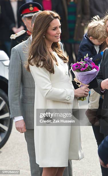 Catherine, Duchess of Cambridge, wearing a cream Jojo Maman Bebe maternity coat, visits cast and crew of Downton Abbey at Ealing Studios in London.