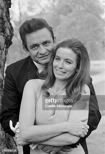 American country singer Johnny Cash with his wife June Carter photographed in a London park during their visit to Britain, a few weeks after their...
