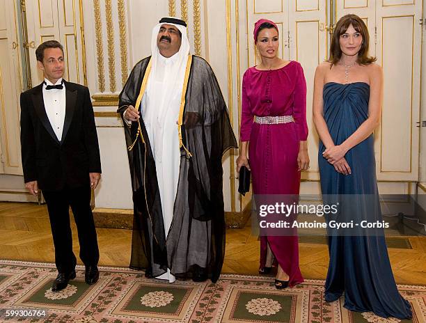 French President Nicolas Sarkozy, Sheikh Hamad Bin Khalifa Al-Thani, Emir of Qatar stand in line with their wives, Sheikha Mozah bint Nasser...