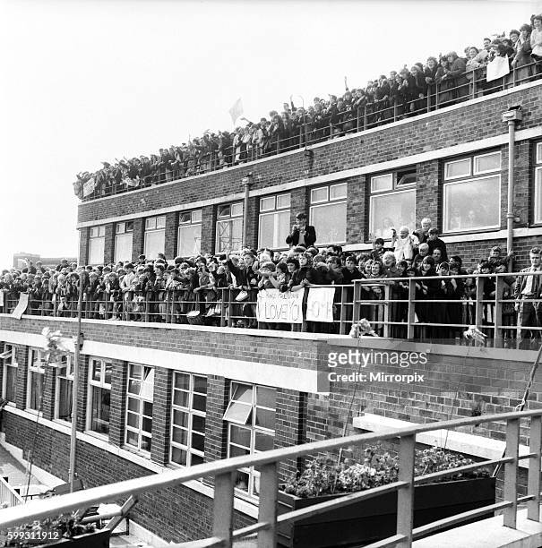 Beatles fans packed onto a building terrace and rooftop as they try to get a glimpse of their heroes before the premiere of the Beatles film 'A Hard...