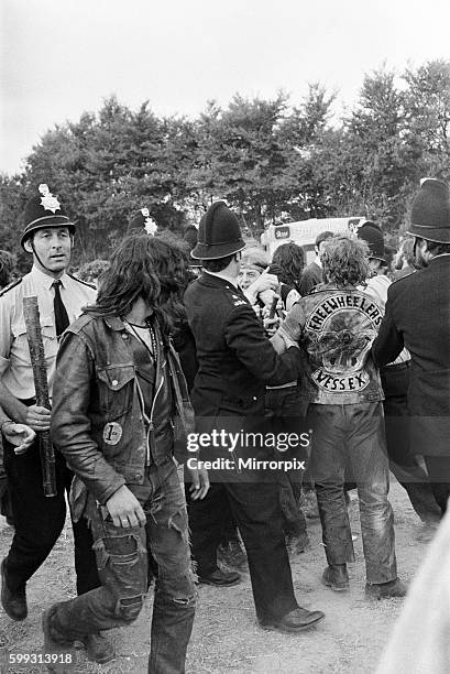 Scene at POP Festival, Weeley, Essex, following a battle between security men and Hells Angels, Hells Angels with police, 28th August 1971.