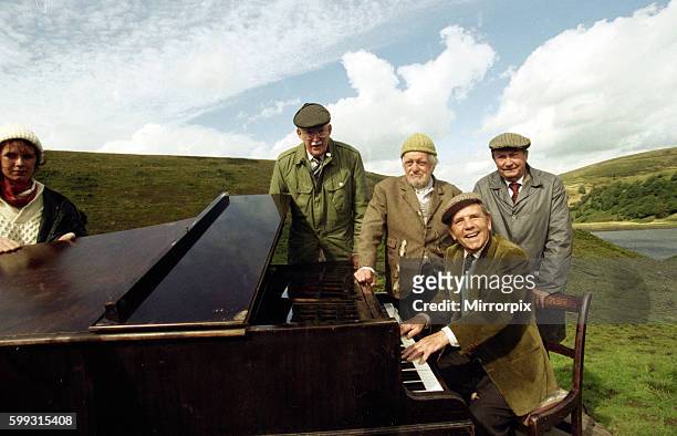 Norman Wisdom in his role as Billy Ingleton the piano player in the BBC situation comedy series Last of the Summer Wine, surrounded by left to right:...