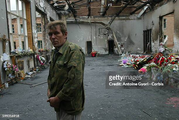 Local inhabitant from Beslan visits the charred remains of the gymnasium where the school siege unfolded. 318 civilians, including 186 children, died...