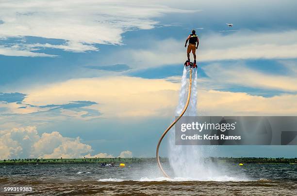 man with flyboard boot of the sea in summer day - deporte de riesgo fotografías e imágenes de stock