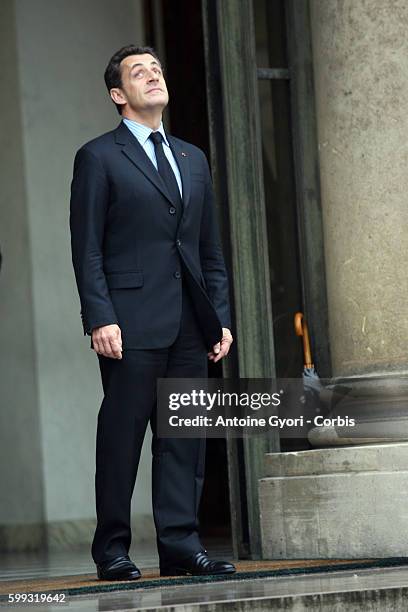 French President Nicolas Sarkozy gestures while waiting for Libyan leader Muammar Gaddafi at the Elysee Palace.