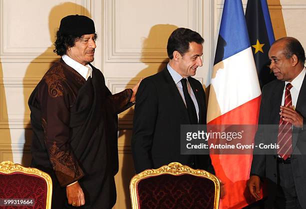 Abdul Rahman Shalgham, President Nicolas Sarkozy and Libyan leader Muammar Gadhafi attend a signing ceremony at the Elysee Palace. The French...